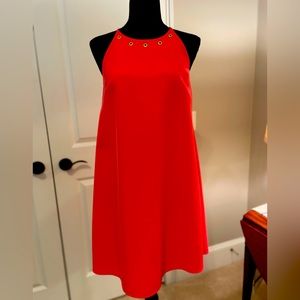 White House Black Market coral halter dress with gold accents.